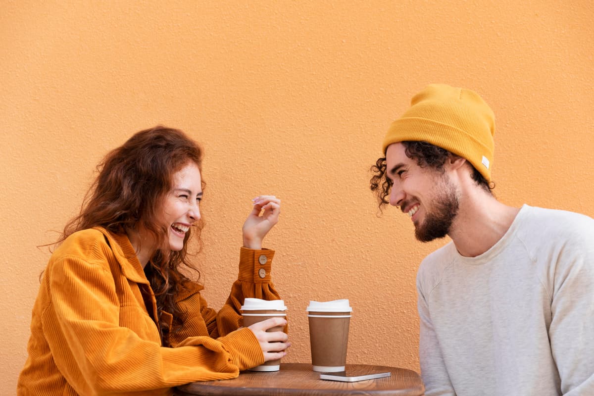 Picture of two people laughing over coffee