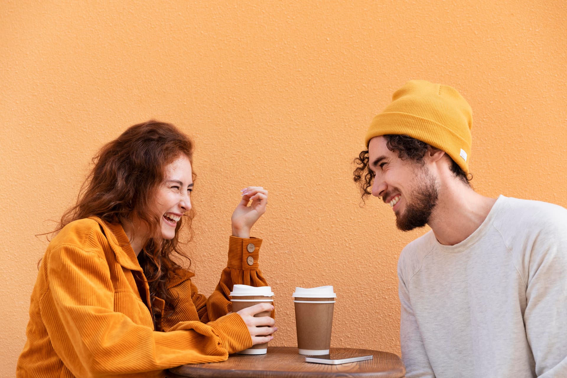 Picture of two people laughing over coffee