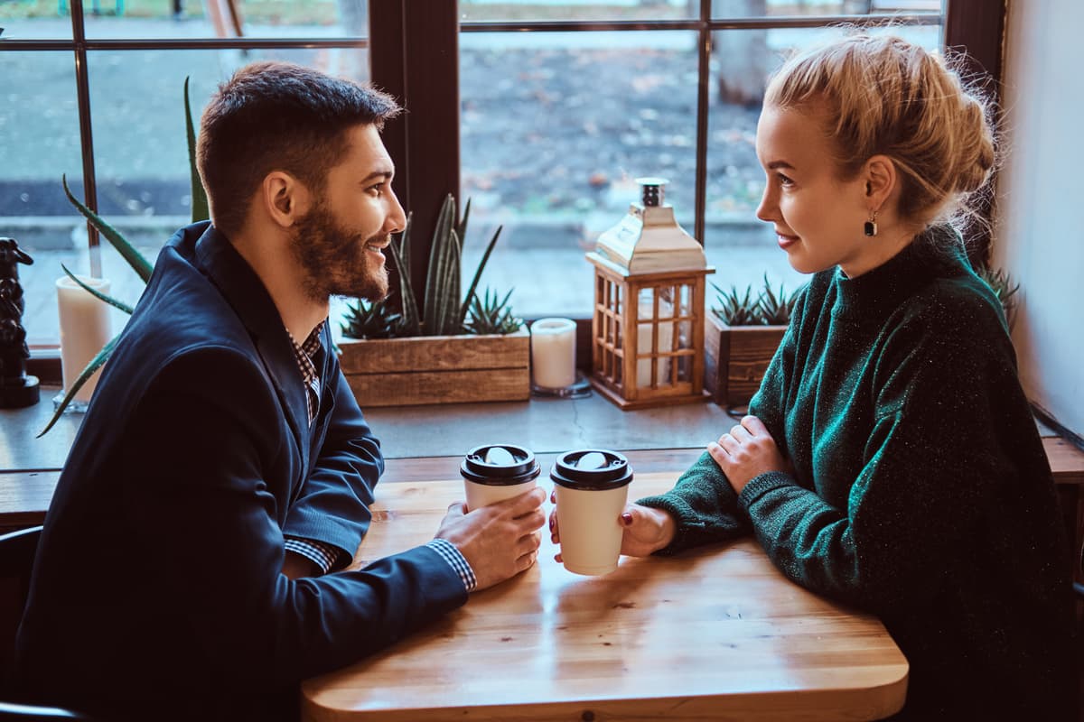 Picture of a couple at a cozy cafe having a good conversation
