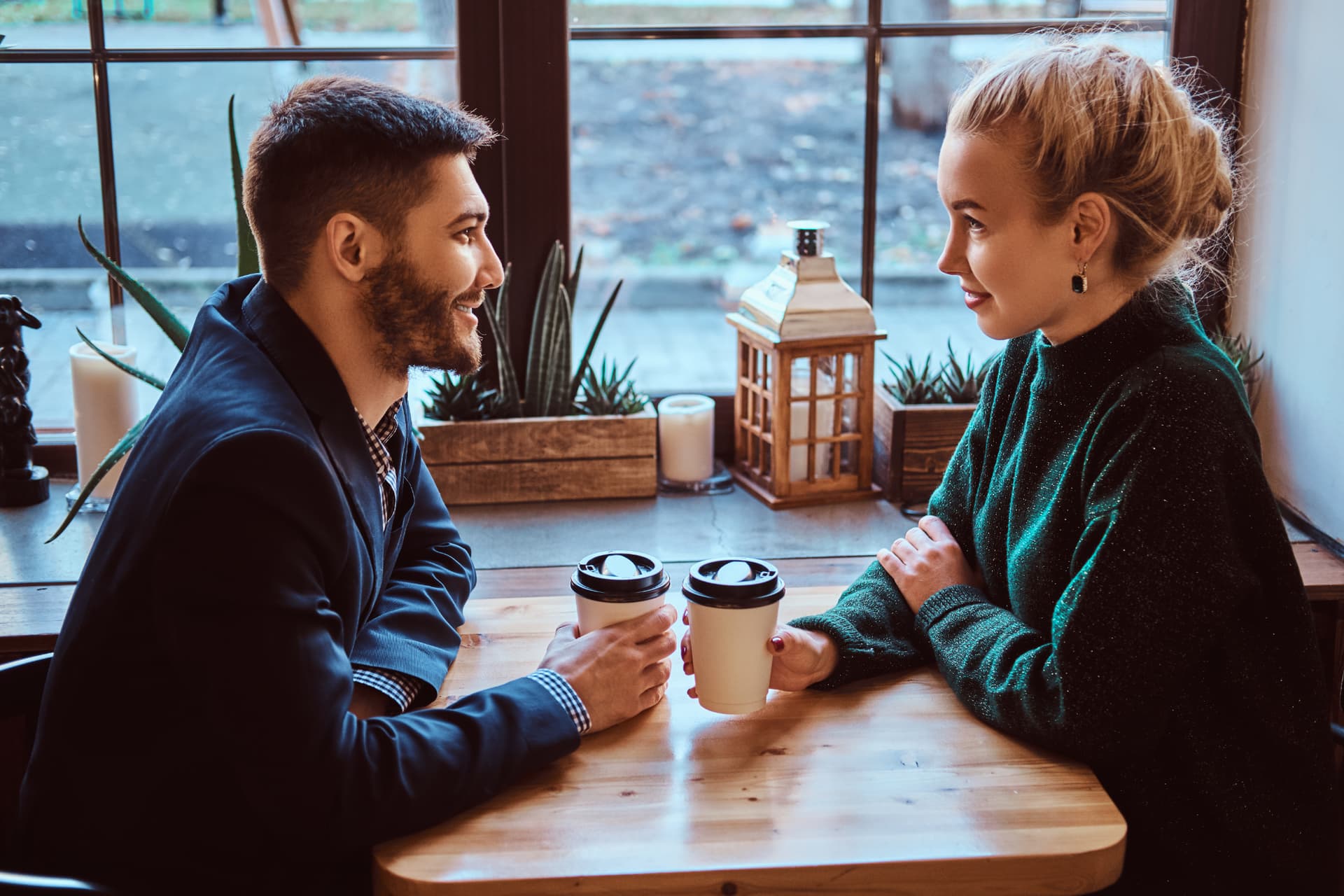 Picture of a couple at a cozy cafe having a good conversation